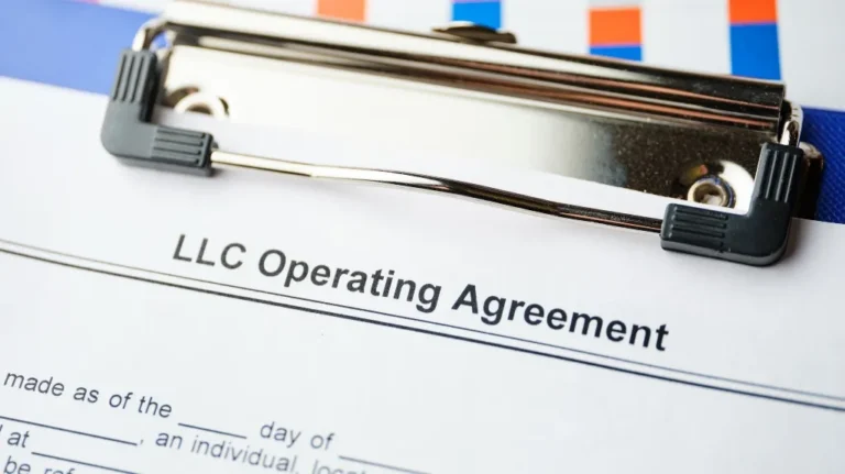 Close-up image of an LLC Operating Agreement document on a blue clipboard.